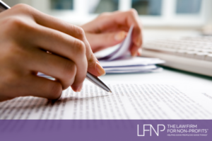 hand holding pen reviewing documents for a private foundation