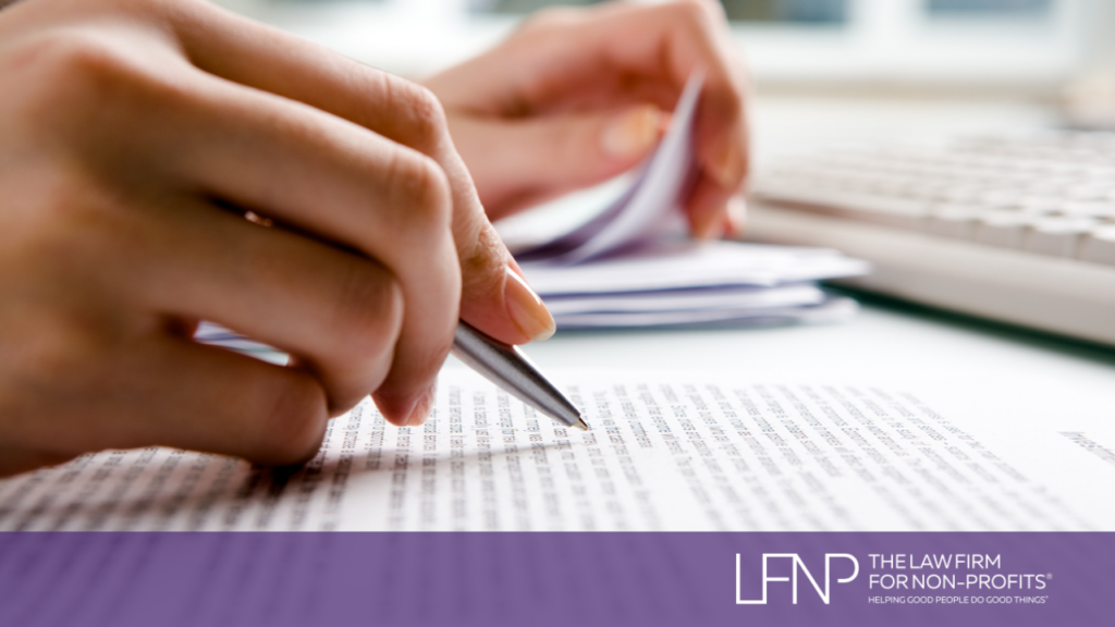 hand holding pen reviewing contracts for private foundation