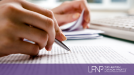 hand holding pen reviewing contracts for private foundation