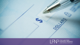 donor writing a chack to make a charitable donation to a nonprofit