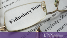 glasses with the words fiduciary duty in the lense on a piece of paper